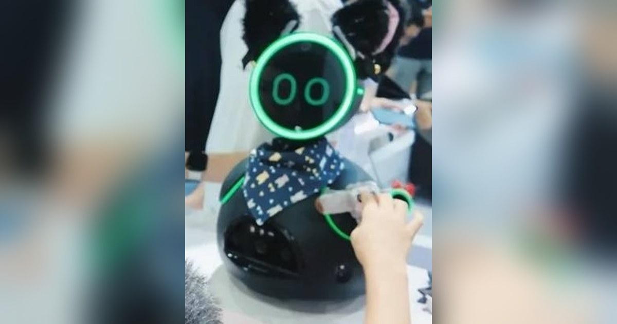 Fotografía recortada de una publicación de INDEMIND de Donutbot negro completo en una demostración de interacción en feria.