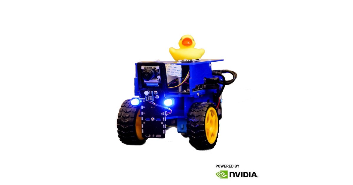 Duckiebot con chasis azul y amarillo, dos ruedas, cámara y un patito de goma encima.