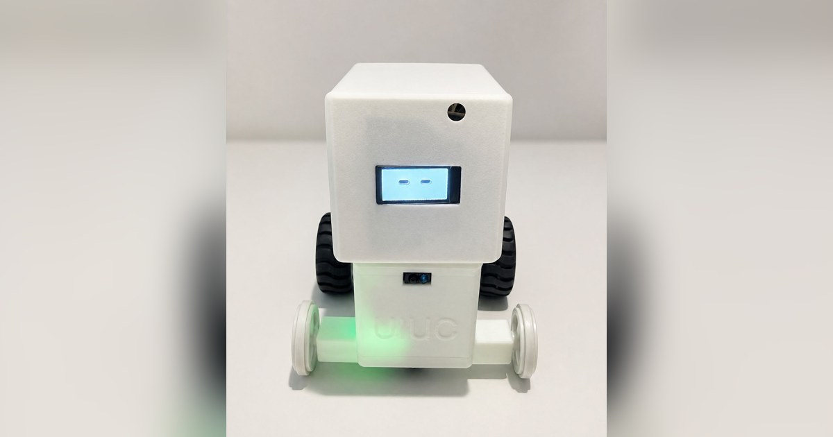 Fotografía del equipo Jarvis de su robot completo, con carcasa blanca, cara en pantalla, dos ruedas negras y ruedas auxiliares claras.
