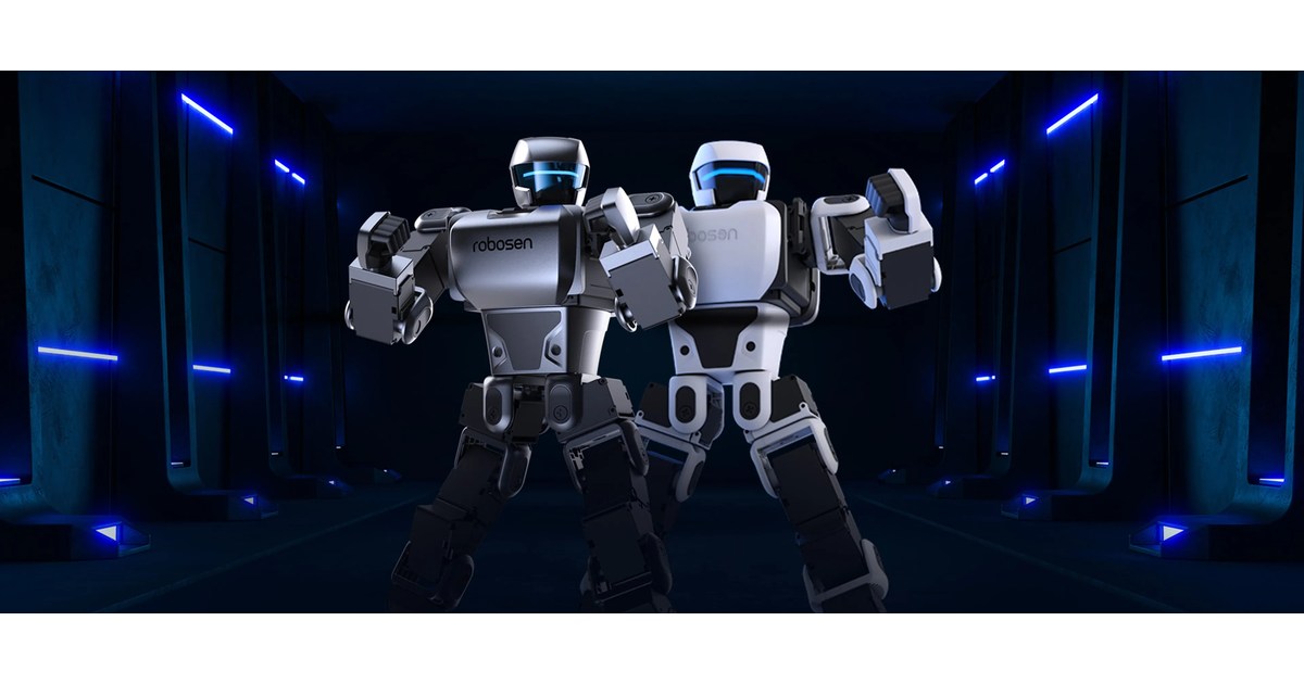 Dos humanoides Robosen de la serie K1, blanco y gris oscuro, en una presentación del fabricante.