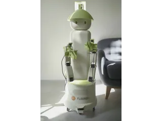Fotografía oficial de Flourish 1 completo, con cuerpo blanco y verde, manipulador frontal y base de ruedas.