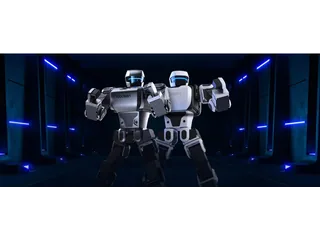 Dos humanoides Robosen de la serie K1, blanco y gris oscuro, en una presentación del fabricante.