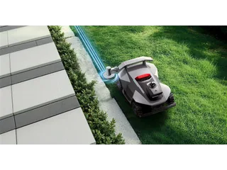 Render oficial de ANTHBOT R7 sobre césped, con el brazo recortabordes extendido junto a un bordillo y líneas azules que ilustran su recorrido.