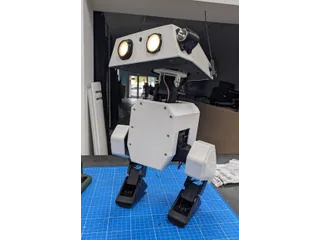 Fotografía del proyecto Open Duck Mini v2 completo sobre una mesa de trabajo, con dos patas y ojos iluminados.