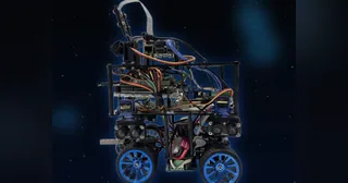Fotografía del equipo RoboPegasus de su vehículo completo, con cuatro ruedas azules, cámara elevada y sensores laterales.