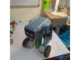 Fotografía de kairobyte del robot completo ensamblado, con dos patas y ruedas, apoyado sobre el banco de trabajo.