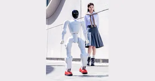 Humanoide Noetix Bumi caminando delante de una persona en una fotografía oficial