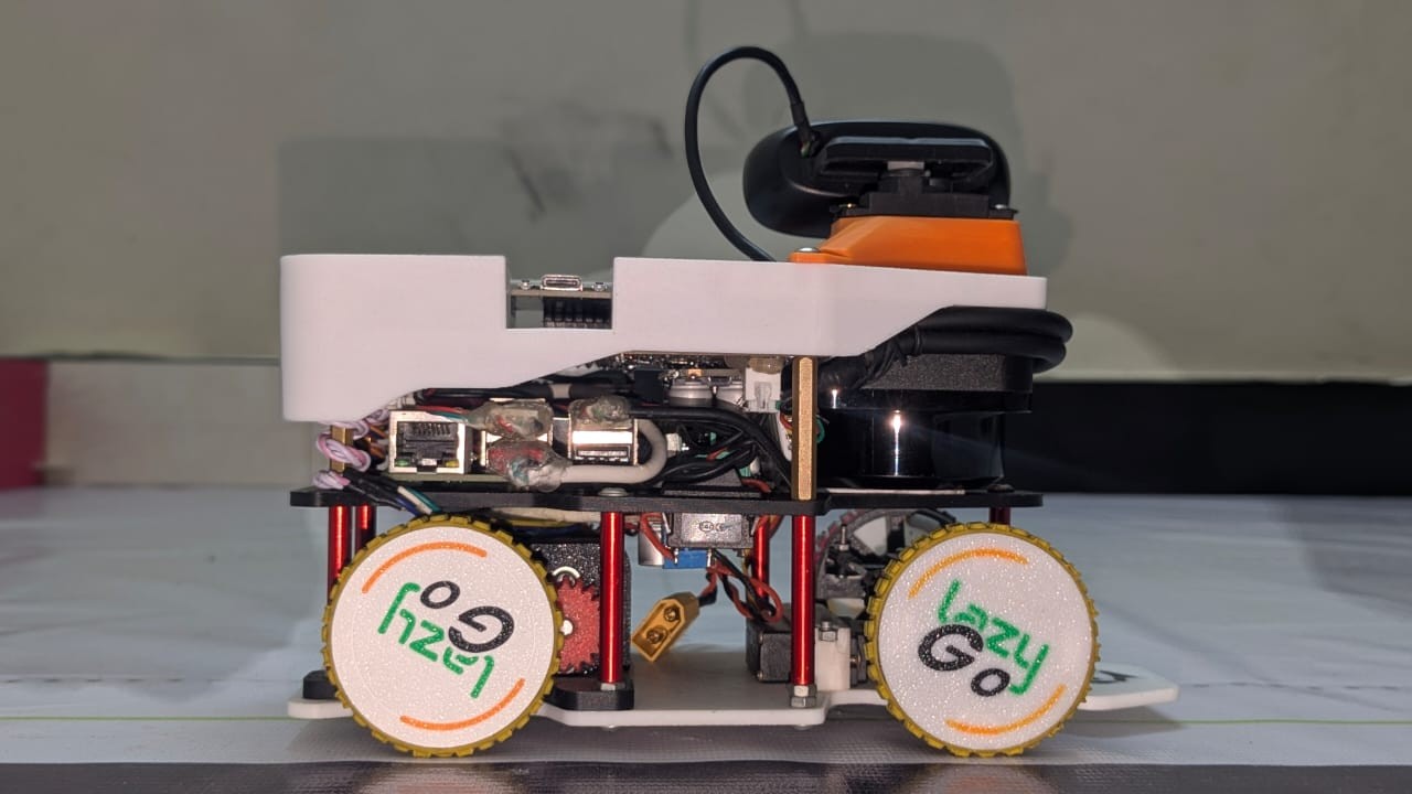 Fotografía del equipo LazyGo de LazyBot completo visto de lado, con cuatro ruedas, lidar y cámara sobre un soporte orientable.